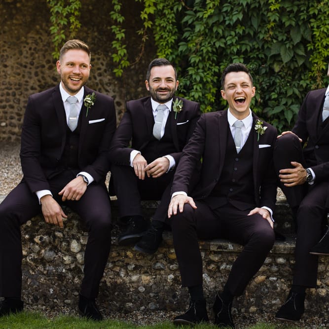 Groom and Groomsmen in Black Three Piece Suits with Grey Ties and Personalised Tie Clips | Ivania Pronovias Wedding Dress with Long Sleeves and Minimalist Styling | Chris Barber Photography