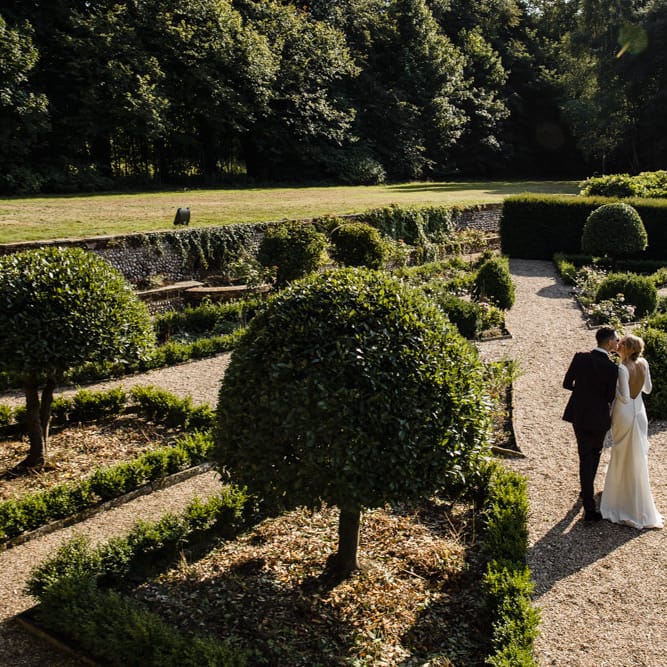 Bride in Long Sleeved Wedding Dress with Plunging V Back and Cuff Buttons by Pronovias | Groom in Black Three Piece Suit with Grey Tie and Personalised Tie Clip | Bridal Up Do | Ivania Pronovias Wedding Dress with Long Sleeves and Minimalist Styling | Chris Barber Photography