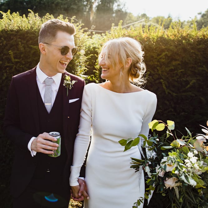Bride in Long Sleeved Wedding Dress with Plunging V Back and Cuff Buttons by Pronovias | Groom in Black Three Piece Suit with Grey Tie and Personalised Tie Clip | Bridal Bouquet of Scabious, Ammi Majus, Veronica, Snowberries, Chocolate Cosmos, Black Scabious, Cafe au Lait Dahlias and Majolica Spray Roses with White Trailing Ribbon | Bridal Up Do | Ivania Pronovias Wedding Dress with Long Sleeves and Minimalist Styling | Chris Barber Photography