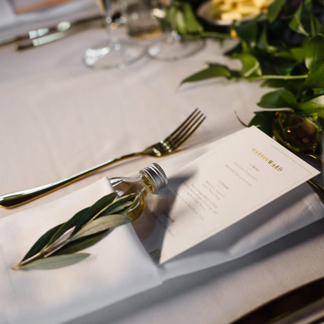 Gold Cutlery | Personalised Wedding Breakfast Menu | Shot Bottle Wedding Favour | Eucalyptus Table Runner | Ivania Pronovias Wedding Dress with Long Sleeves and Minimalist Styling | Chris Barber Photography