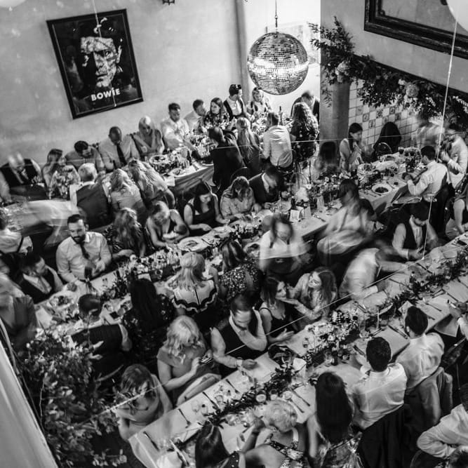 Wedding Reception at Voewood | Banquet Tables | Glitter Balls | Table Flowers in Concrete Single Stem Vessels | Eucalyptus Table Runners | Ivania Pronovias Wedding Dress with Long Sleeves and Minimalist Styling | Chris Barber Photography