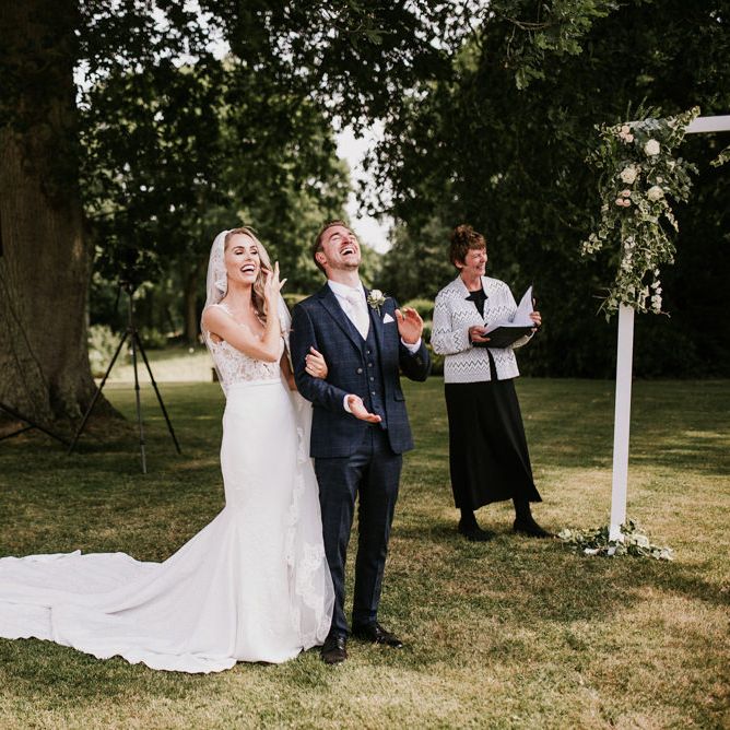 Bride and Groom Laughing During Outdoor Wedding Ceremony