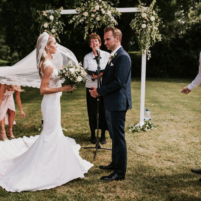 Wedding Ceremony with Bride in Pronovias Wedding Dress and Groom in Moss Bros. Suit