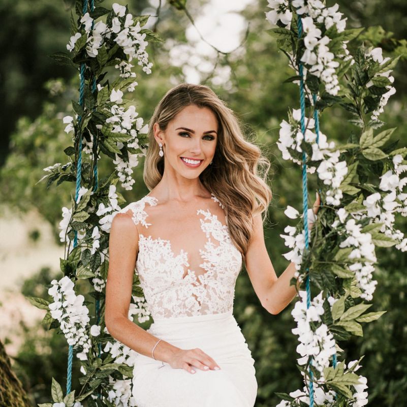 Bride in Pronovias Wedding Dress Sitting on a Ivy Covered Swing