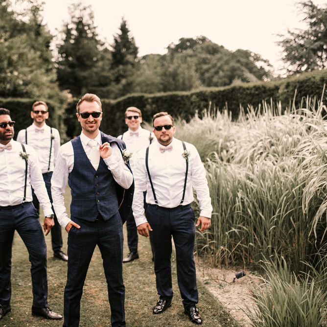 Stylish Groomsmen in Braces and Groom in Check Moss Bros. Suit