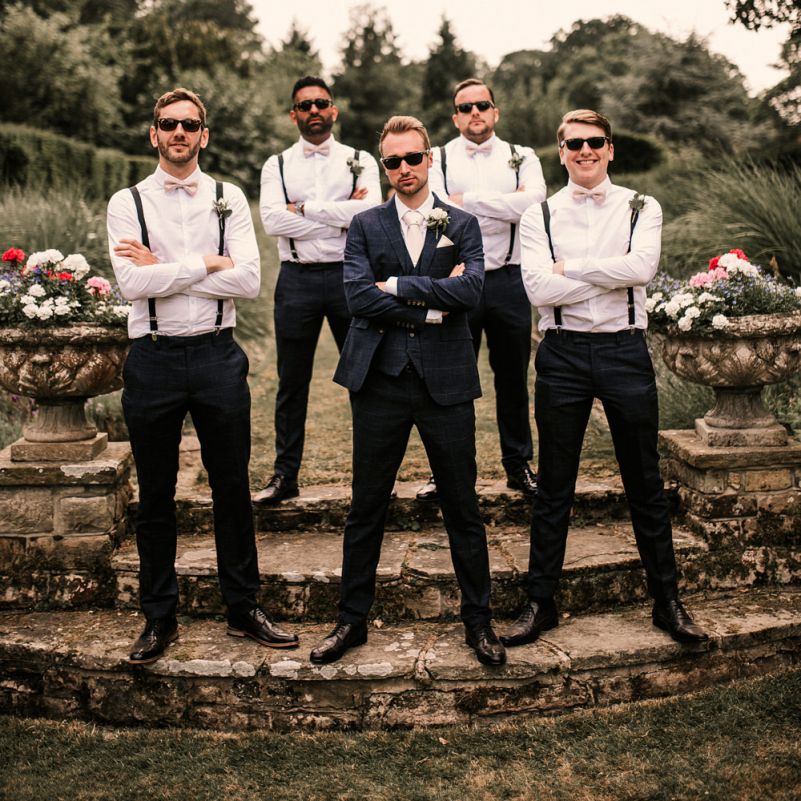 Stylish Groomsmen in Braces and Groom in Check Moss Bros. Suit
