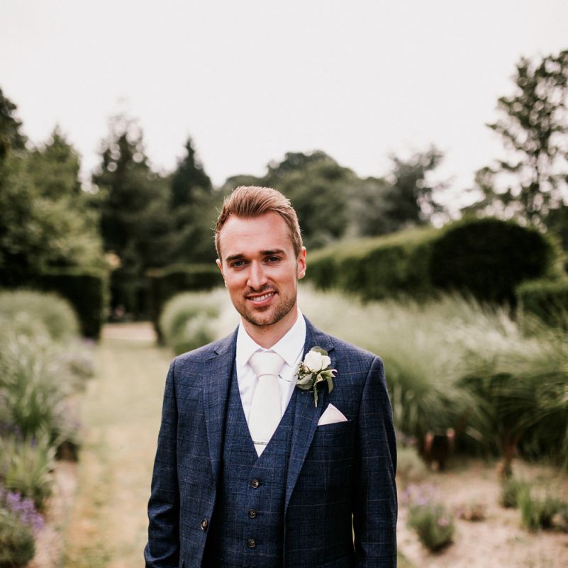 Groom in Navy Check Moss Bros Suit