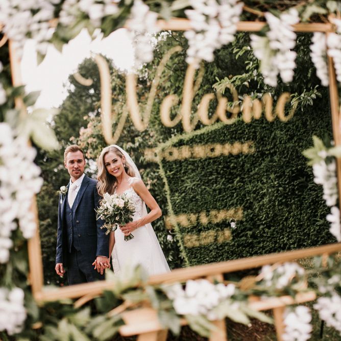Gold Framed Mirror Wedding Welcome Sign with Reflection of Bride and Groom