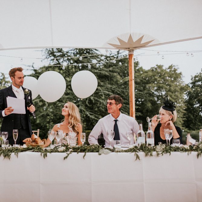 Groom in Navy Check Moss Bros Suit  Giving Speech During Wedding Reception