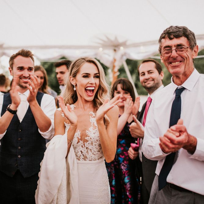 Bride and Groom Laughing During Wedding Entertainment