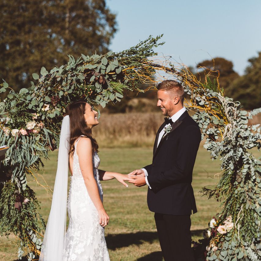Bride and groom tie the knot at Crouchers Orchards with hoop foliage decor