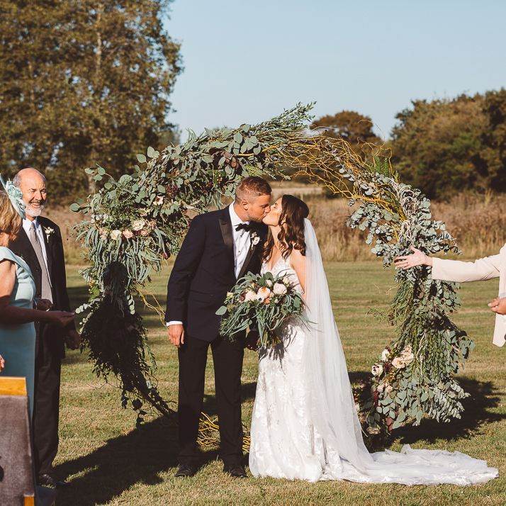 Intimate wedding ceremony at Crouchers Orchards with foliage hoop decor and eucalyptus chair decor