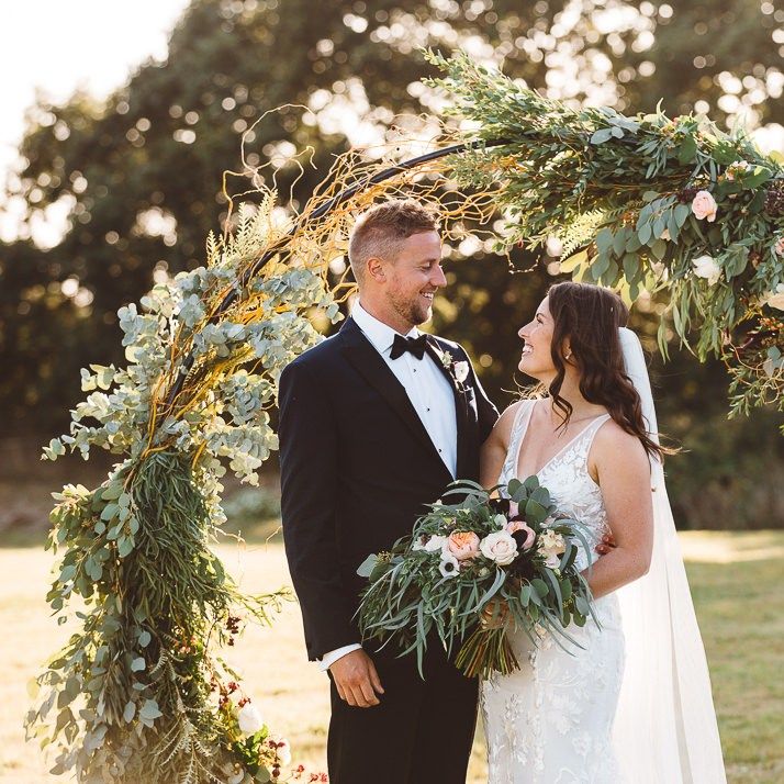 Bride wearing beautiful Made With Love Bridal dress and groom wearing black tie suit