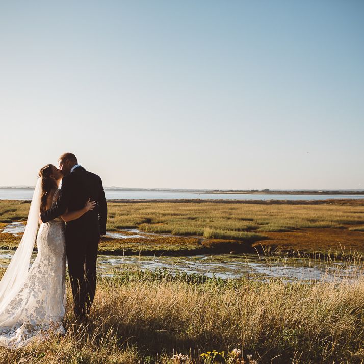 Bride and groom embrace at outdoor wedding