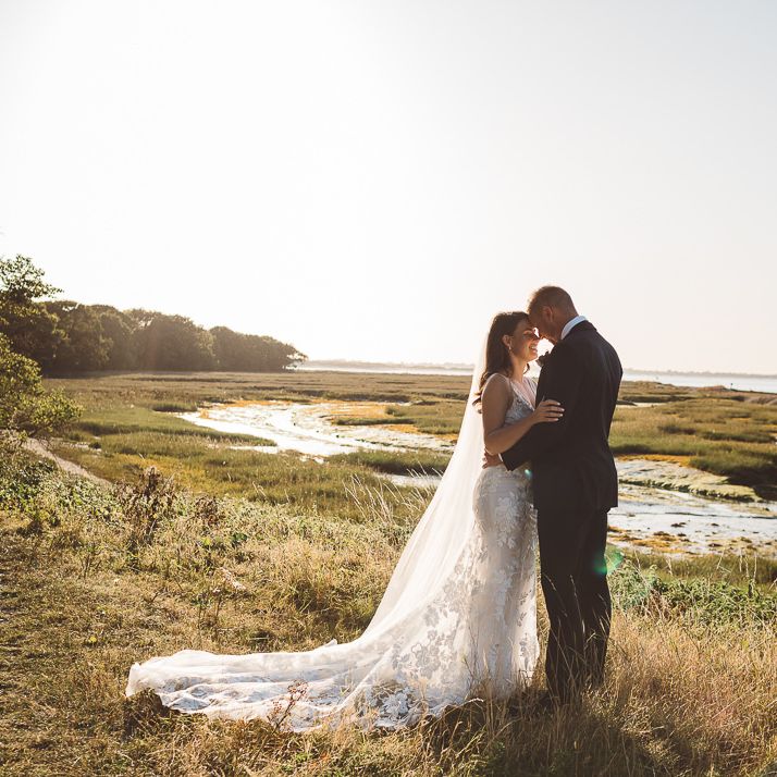 Bride and groom embrace at Crouchers Orchards for outdoor wedding