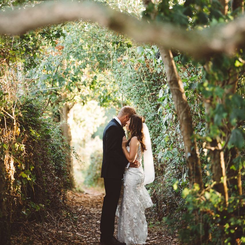 Bride and groom embrace at Crouchers Orchards for outdoor wedding