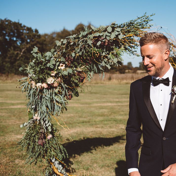 Aisle hoop decor styled with eucalyptus and foliage at Crouchers Orchards for outdoor ceremony