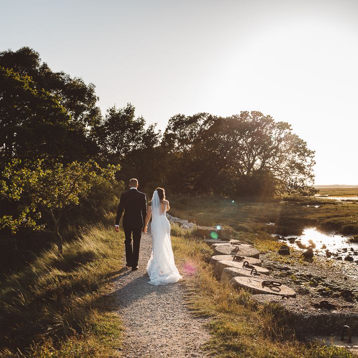 Bride and groom embrace at Crouchers Orchards for outdoor wedding