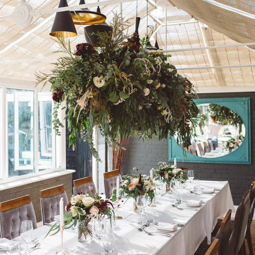 Hanging foliage styled with florals and eucalyptus for intimate reception with seven guests