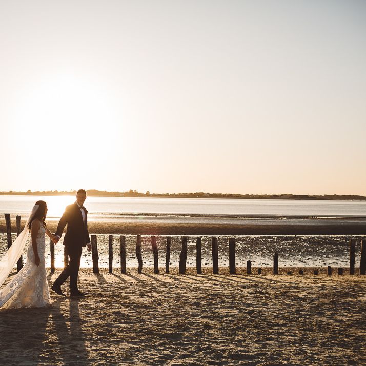 Bride and groom enjoy a beach shoot together at golden hour