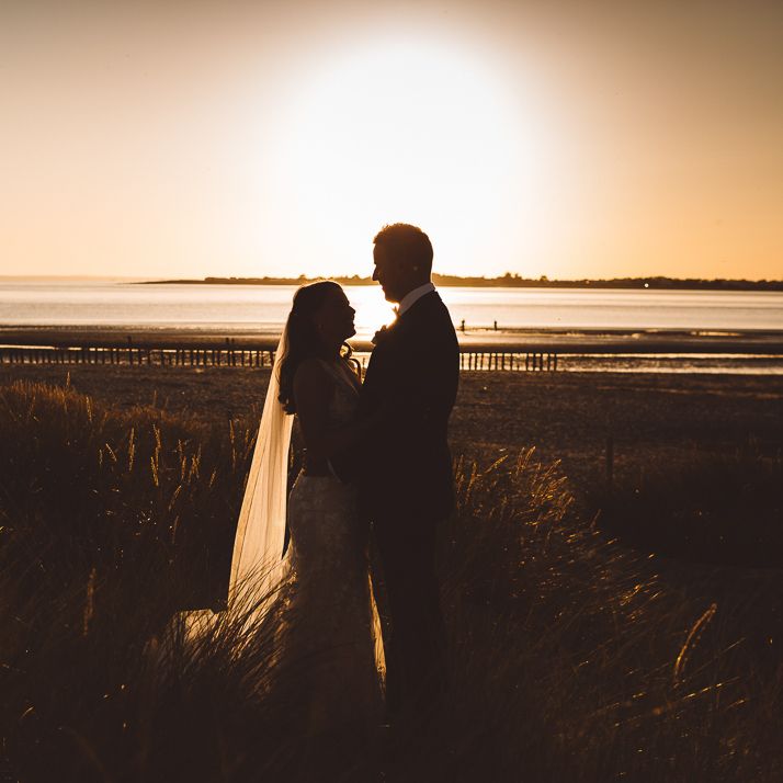 Bride and groom enjoy a beach shoot together at golden hour