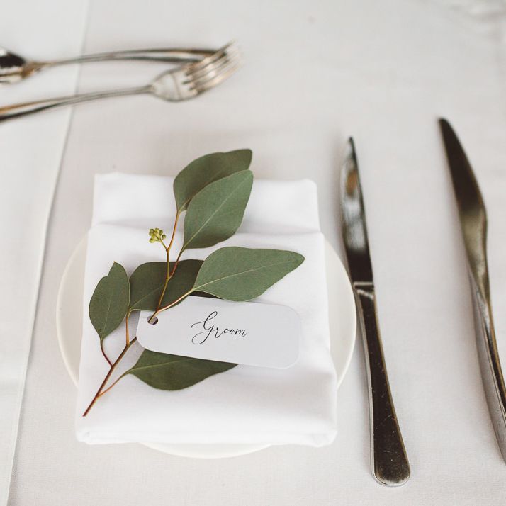 Place settings for intimate wedding styled with eucalyptus