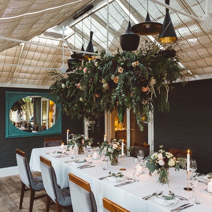 Beautiful hanging foliage styled with eucalyptus for a romantic and intimate dinner