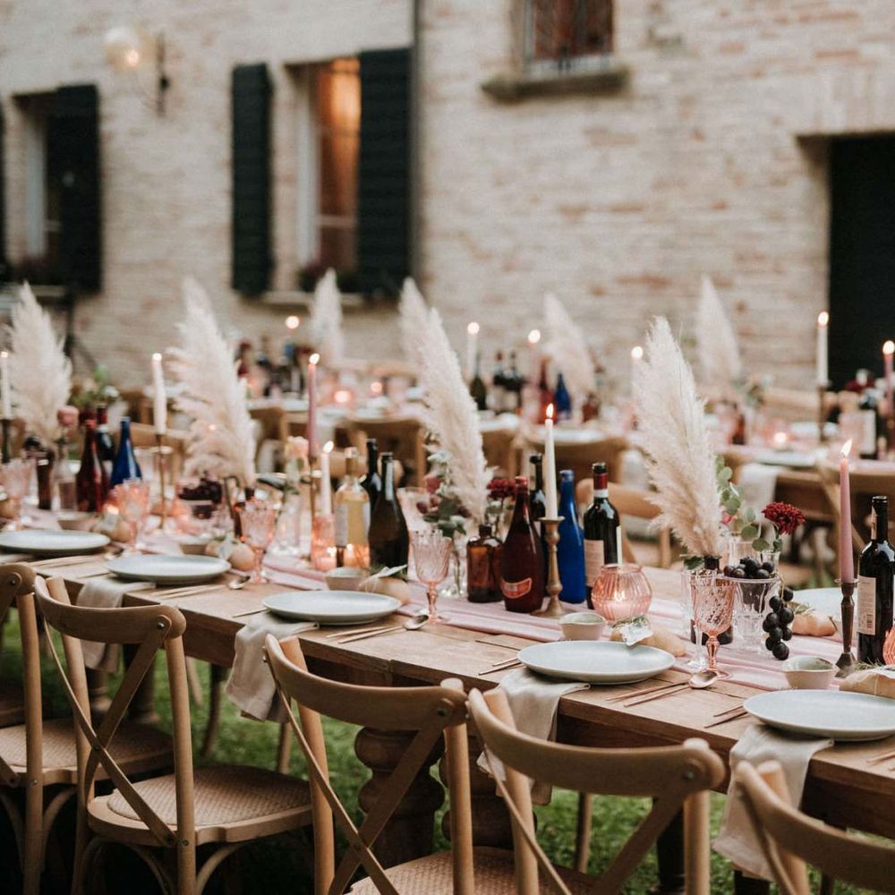 Gorgeous wedding table decor with pampas grass, blush candles and pink glassware