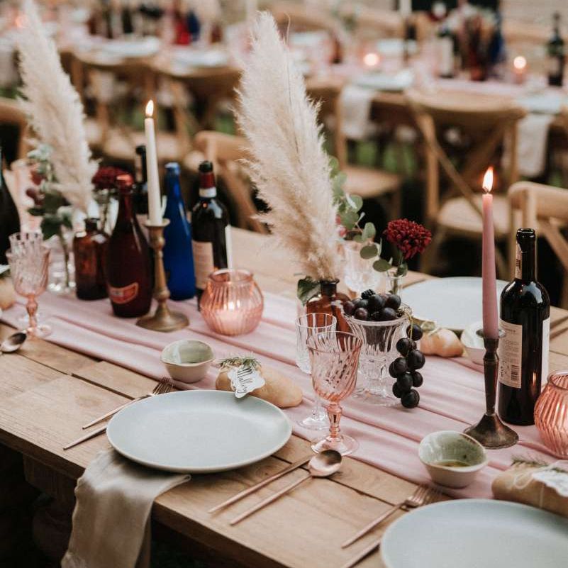 Gorgeous wedding table decor with pampas grass, blush candles and pink glassware
