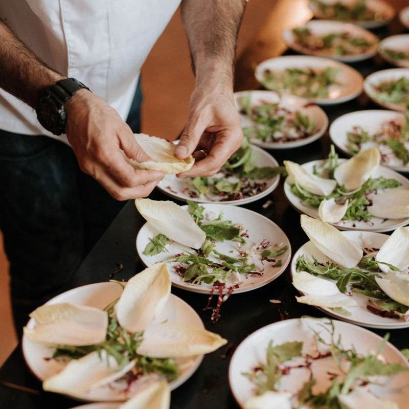 Chefs prepare wedding breakfast at Italian wedding
