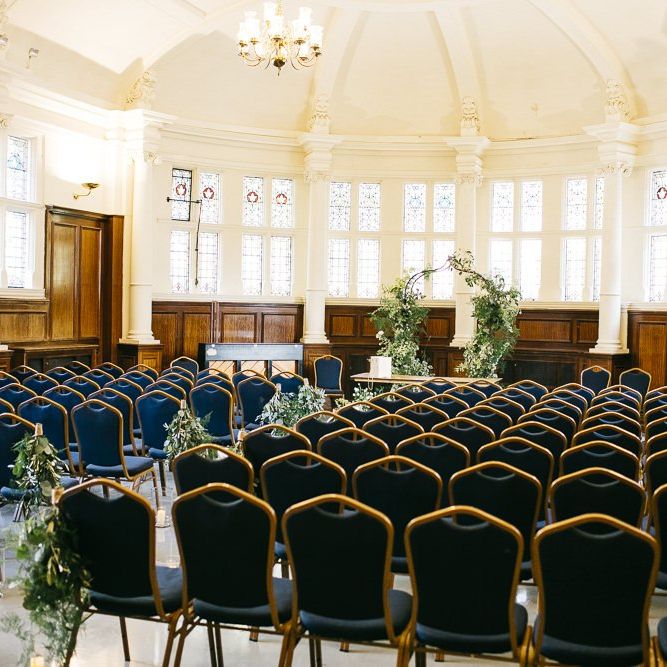 London ceremony with green and white foliage decor