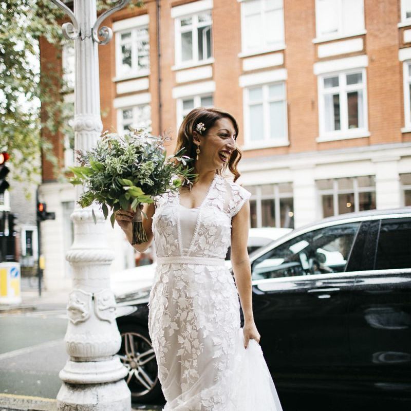 Bride wearing Phase Eight Wedding Dress teamed with hair accessory and white foliage bouquet
