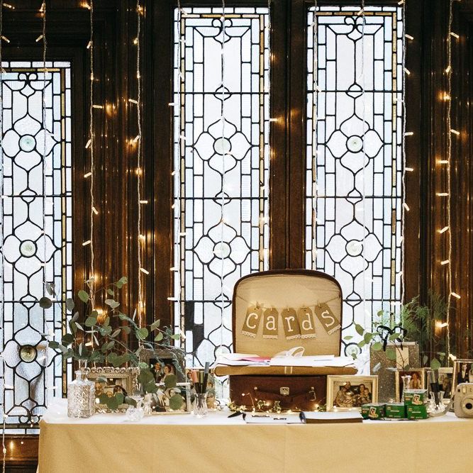 Foliage decor at London celebration with fairy lights and  personalised card case