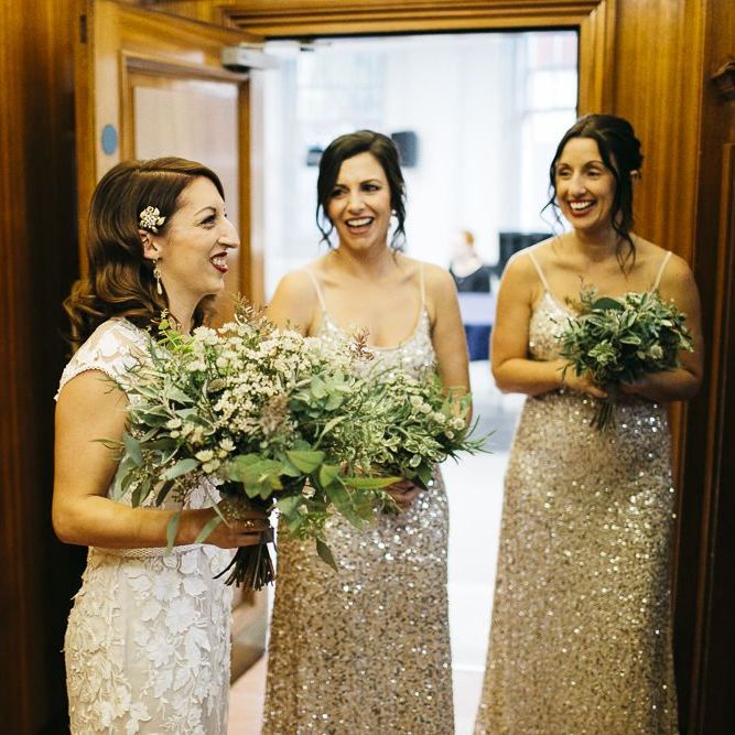 Bride wearing Phase Eight Wedding Dress and her bridesmaids wearing embellished dresses teamed with white foliage bouquets