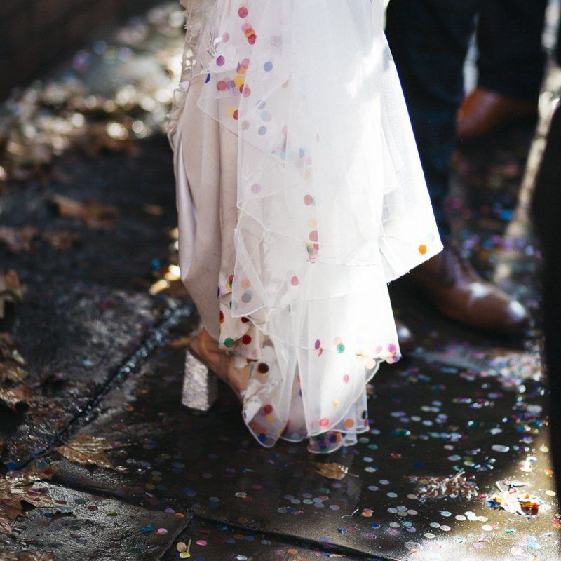 Bride wearing Phase Eight Wedding Dress and multi coloured confetti