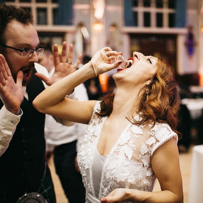 Bride having a vodka jelly shot with guests at London celebration