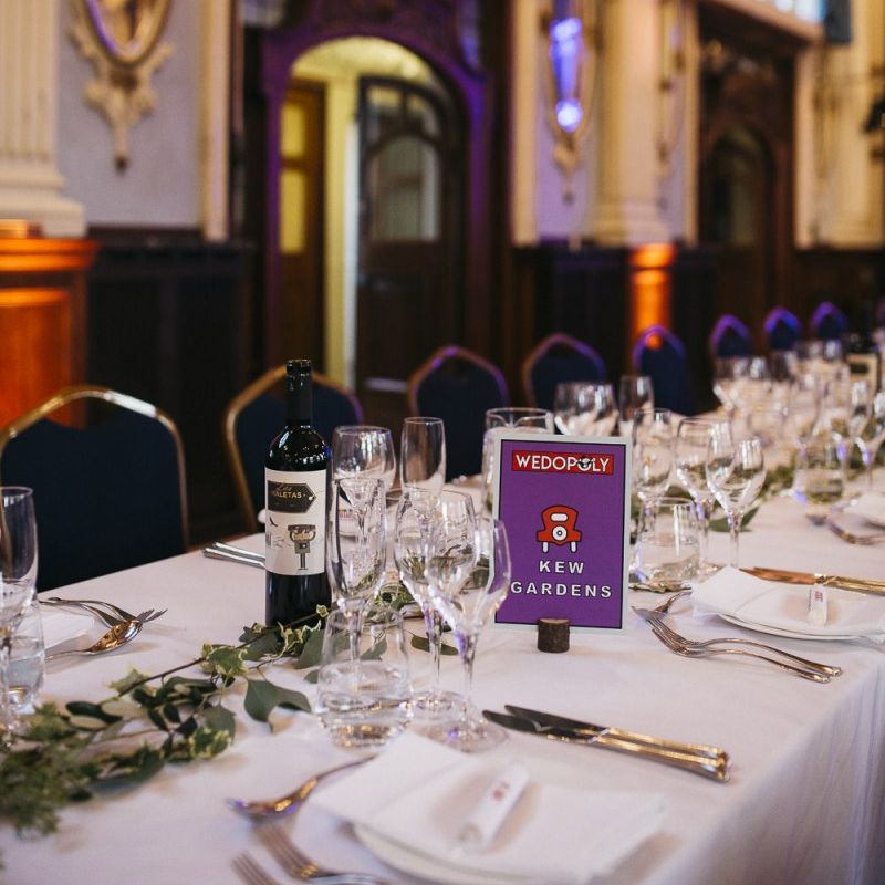 Monopoly style table plan settings with foliage decor at autumnal reception