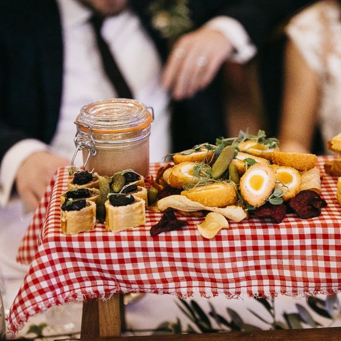 Food at reception with red gingham styling