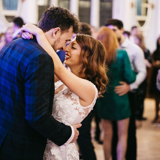 Bride and groom dance with their friends and family