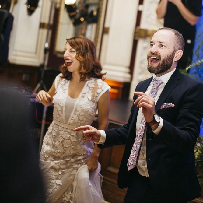 Bride and groom dance with their friends and family