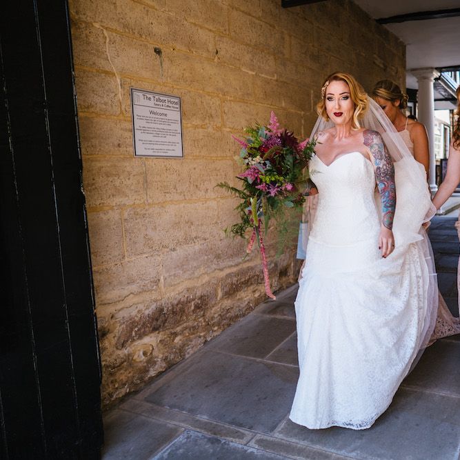 Arrival of the Bride | Bride in Strapless Sassi Holford Wedding Dress with Sweetheart Neckline | Bridesmaids in Pink Dessy Dresses | Edison Bulb Floral Installation at Kingsthorpe Lodge Barn Wedding | Johnny Dent Photography