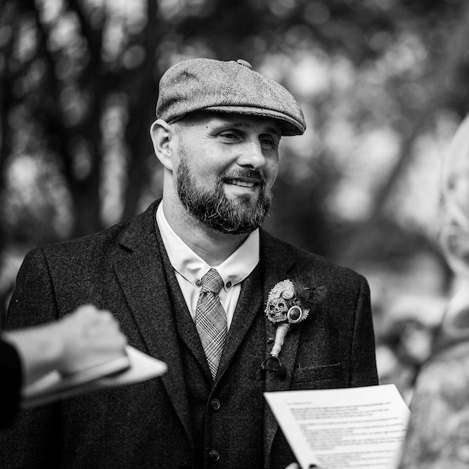 Wedding Ceremony | Bride in Strapless Sassi Holford Wedding Dress with Sweetheart Neckline | Groom in Burgundy Tweed Three Piece Suit | Edison Bulb Floral Installation at Kingsthorpe Lodge Barn Wedding | Johnny Dent Photography