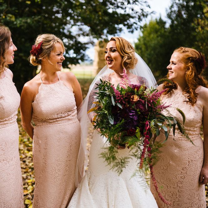 Bride in Strapless Sassi Holford Wedding Dress with Sweetheart Neckline | Bridesmaids in Pink Dessy Dresses | Edison Bulb Floral Installation at Kingsthorpe Lodge Barn Wedding | Johnny Dent Photography