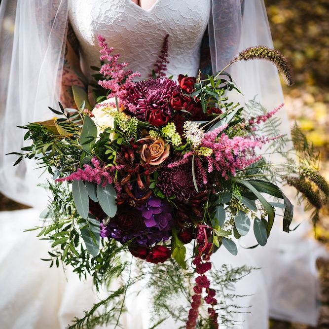 Bright Bouquet | Bride in Strapless Sassi Holford Wedding Dress with Sweetheart Neckline | Edison Bulb Floral Installation at Kingsthorpe Lodge Barn Wedding | Johnny Dent Photography