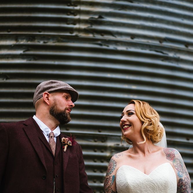 Bride in Strapless Sassi Holford Wedding Dress with Sweetheart Neckline | Groom in Burgundy Tweed Three Piece Suit | Edison Bulb Floral Installation at Kingsthorpe Lodge Barn Wedding | Johnny Dent Photography