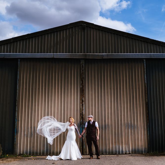 Bride in Strapless Sassi Holford Wedding Dress with Sweetheart Neckline | Groom in Burgundy Tweed Three Piece Suit | Edison Bulb Floral Installation at Kingsthorpe Lodge Barn Wedding | Johnny Dent Photography