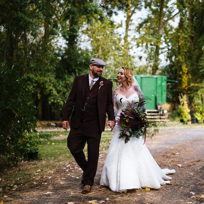 Bride in Strapless Sassi Holford Wedding Dress with Sweetheart Neckline | Groom in Burgundy Tweed Three Piece Suit | Edison Bulb Floral Installation at Kingsthorpe Lodge Barn Wedding | Johnny Dent Photography