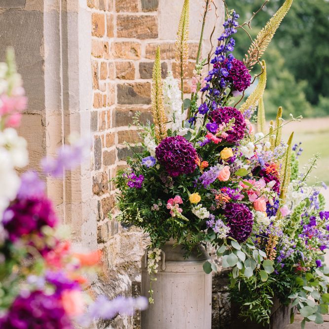 Brightly Coloured Floral Arrangements In Urns // Image By Studio TM