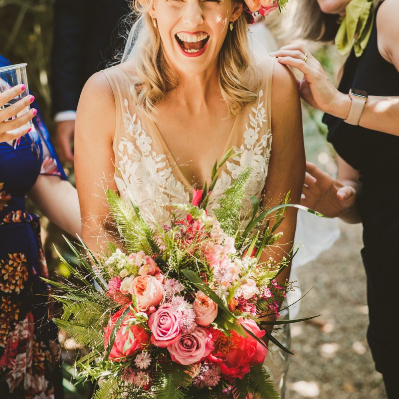 Bride in lace wedding dress with pink peony and rose flower crown