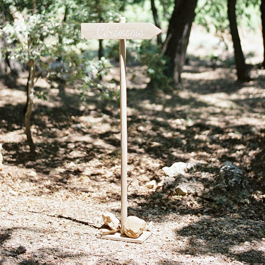 Wooden Wedding Sign | Outdoor Wedding at Commanderie de Peyrassol, Provence, France Styled by La Chuchoteuse | Lace Bridal Gown | Black Tie Suit | Rustic Stretch Tent Reception | Raisa Zwart Photography